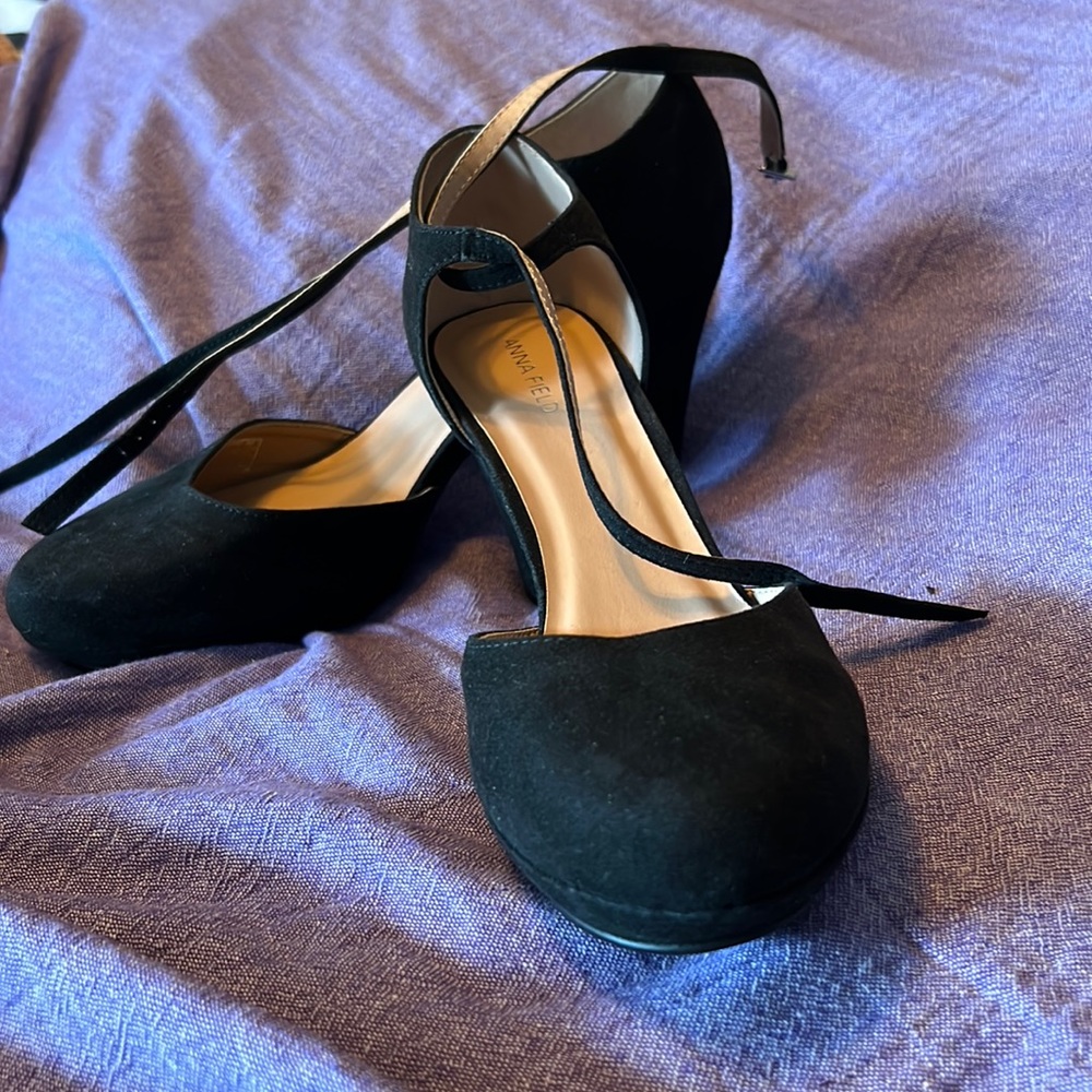 Black round toe pumps with ankle straps.